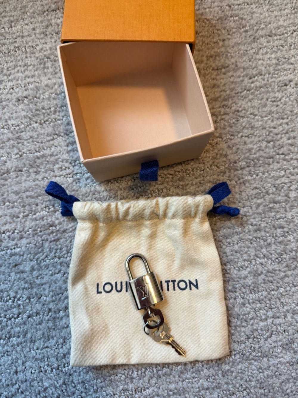 Louis Vuitton Silver-tone Padlock with Gold Key on Cream Pouch